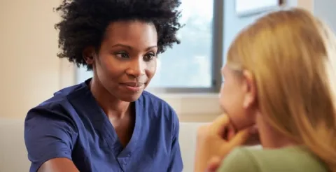 A dedicated nurse providing professional mental health support to a patient in need.