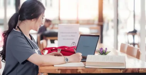 Nursing student engaging with advanced clinical curriculum through a flexible online postgraduate study platform.