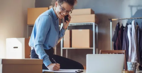 Happy woman working as an entrepreneur and sharing her expert tips for business success.