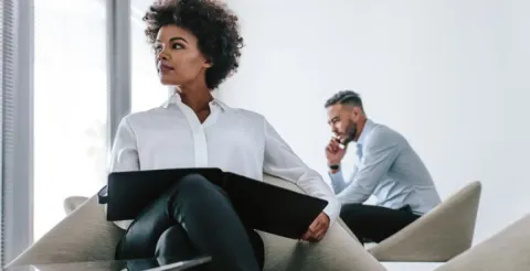 Happy woman working as an entrepreneur and sharing her expert tips for business success.